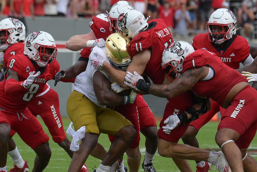 The NC State defense stands up the Notre Dame running back during the Wolfpack's home opener against the Notre Dame Fighting Irish in Carter-Finely Stadium on Saturday, Sept. 9, 2023. After a severe rain delay, the Irish defeated the Wolfpack 45-24.