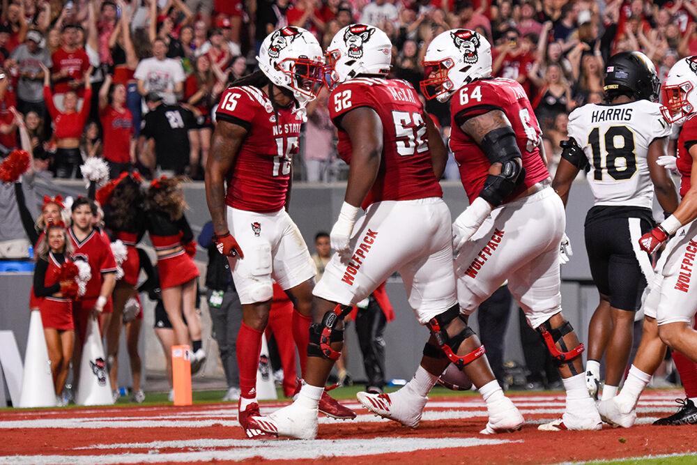 Junior wide receiver Keyon Lesane (left), sophomore offensive lineman Timothy McKay (middle) and graduate offensive guard Chandler Zavala celebrate touchdown during the game against Wake Forest at Carter-Finley Stadium on Saturday, Nov. 5, 2022. Lesane had 79 recoveries. The Wolfpack beat the Demon Deacons 30-21.