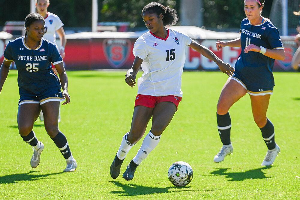 Senior forward Jameese Joseph dribbles through defenders during the match against Notre Dame at Dail Soccer Field on Sunday, Oct. 22, 2023. NC State lost to Notre Dame 1-0.