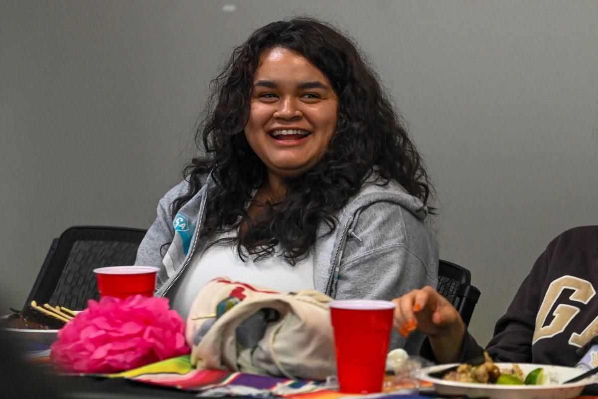 Xiomara Alcantara Ocampo, a third-year studying social work, laughs at the Latinx Heritage Month Chat n Chew at Witherspoon Student Center on Sept. 27, 2023. This event allowed students of Latinx heritage to discuss their experiences on campus over dinner.