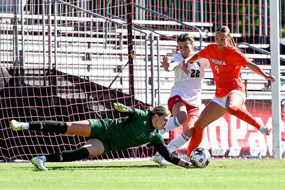 Junior goalkeeper Olivia Pratapas dives to stop a goal during the match versus the Virginia Cavaliers at Dail Soccer Field on Sunday, Oct. 8, 2023. Pratapas had 4 saves against Virginia. The Wolfpack beat the Cavaliers 2-1.