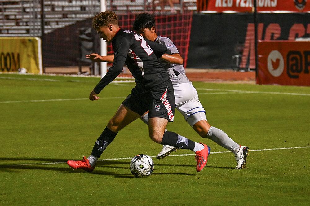 Sophomore midfielder Drew Lovelance controls the ball in the match against the American University Eagles at Dail Soccer Field on Tuesday, Oct. 10, 2023. The Wolfpack lost to the Eagles 2-1.