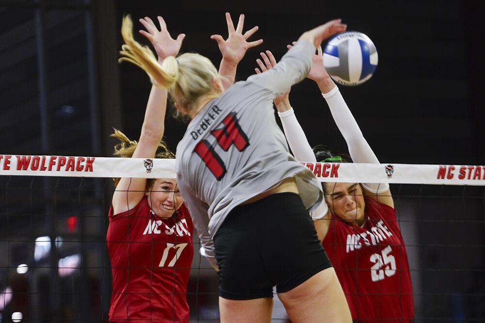 Junior opposite hitter Amanda Rice and senior middle blocker Riley Shaak jumps to block the ball during the match against Louisville in Reynolds Coliseum on Sunday, Oct. 1, 2023. NC State beat Louisville 3-1.