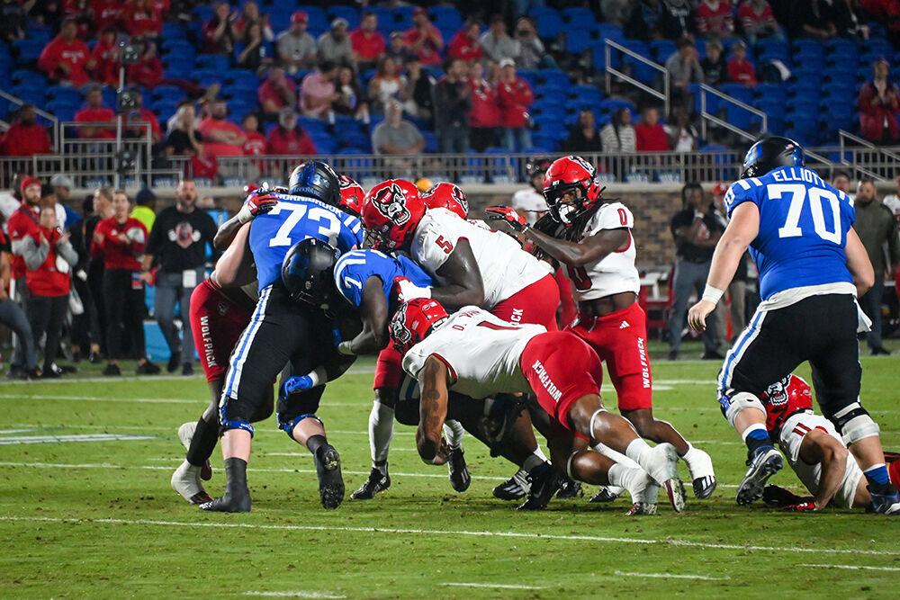 Junior defensive tackle Davin Vann and redshirt junior defemsive tackle C.J. Clark combine to take down a Blue Devils player during the Wolfpack's game against the Duke Blue Devils at Wallace Wade Stadium on Saturday, Oct. 14, 2023. Vann and Clark both had 3 tackles. The Blue Devils beat the Wolfpack 24-3.