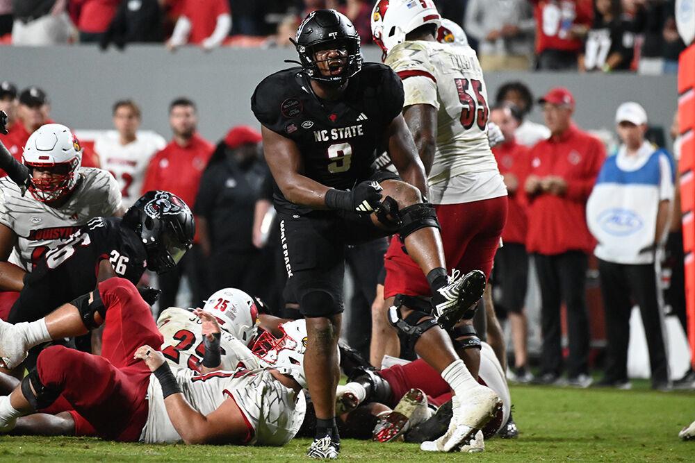 Senior defensive end Savion Jackson celebrates a defensive stop during the Wolfpack's home football game against The Louisville Cardinals at Carter-Finley Stadium on Friday, Sept. 29, 2023. The Cardinals beat the Wolfpack 13-10.
