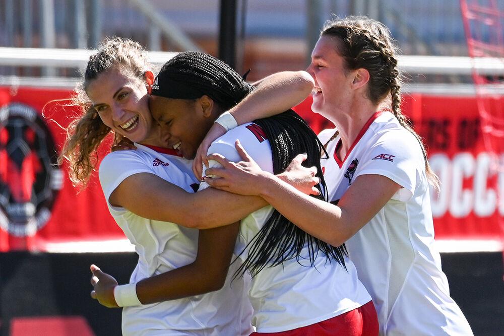 Junior midfielder Annika Wohner, freshman forward Hannah Jibril and sophomore defender Taylor Chism celebrate during the match against Virginia at Dail Soccer Field on Sunday, Oct. 8, 2023. Wohner scored one goal and Jibril made one assist. NC State beat Virginia 2-1.