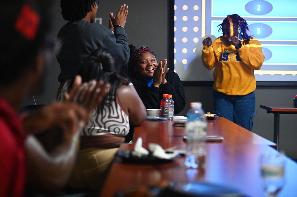 Tiani Hinnant, a fourth-year studying fashion design, claps during Family Feud at Witherspoon Student Center on Friday, Oct. 6, 2023. This was one of the many events held during National Pan-Hellenic Council Week at NC State.