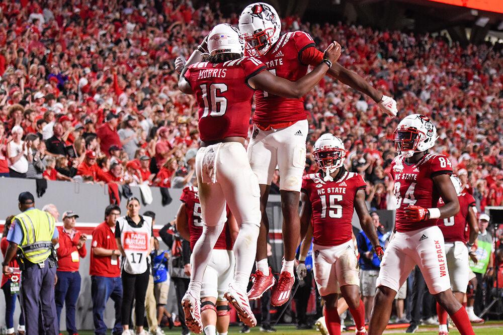 Freshman quarterback MJ Morris (left) and graduate wide receiver Darryl Jones (right) celebrate a touchdown during the game against Wake Forest at Carter-Finley Stadium on Saturday, Nov. 5, 2022. Morris gained 67 yards and Jones had two touchdowns.&#160;The Wolfpack beat the Demon Deacons 30-21.