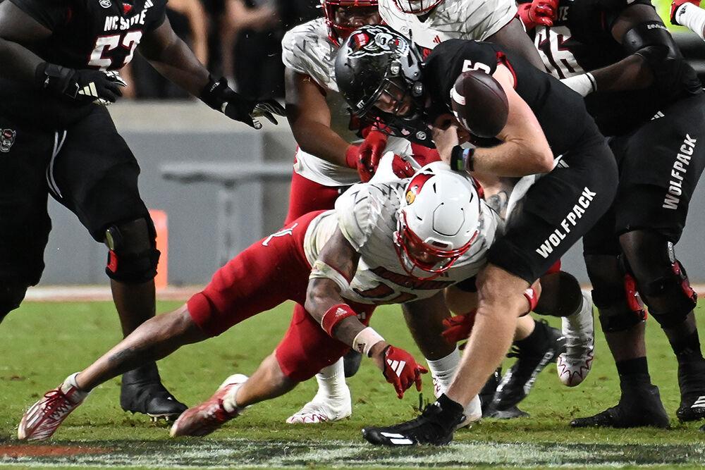 Graduate quarterback Brennan Armstrong fumbles the football during the Wolfpack's home football game against the Louisville Cardinals at Carter-Finley Stadium on Friday, Sept. 29, 2023. The Cardinals beat the Wolfpack 13-10.