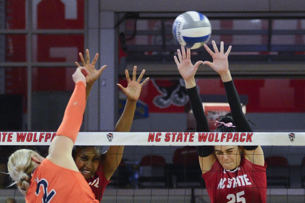 Redshirt junior outside hitter Madison Williams and senior middle blocker Riley Shaak block the ball during the match versus Virginia at Reynolds Coliseum on Sunday, Oct. 22, 2023. NC State beat Virginia 3-0.