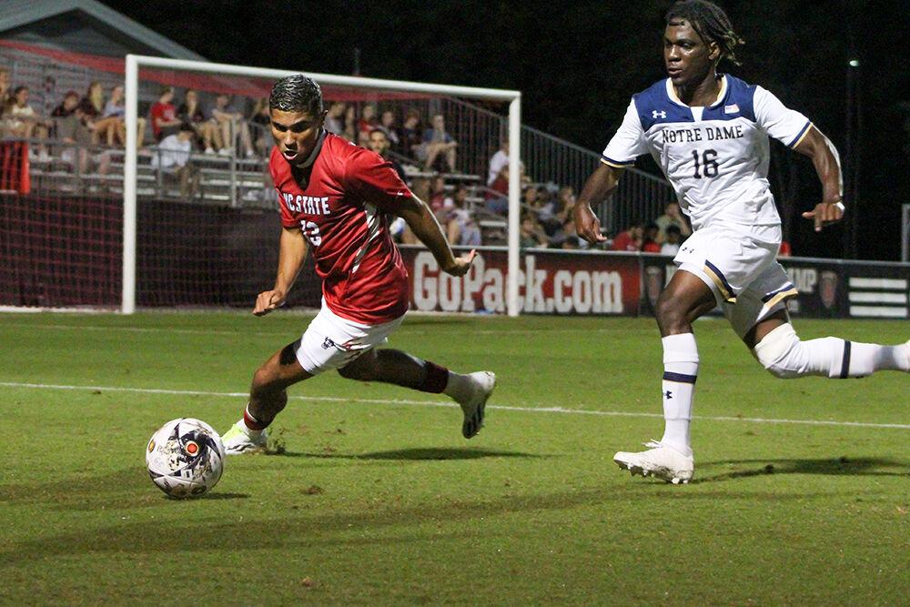 Sophomore midfielder Calem Tommy beats a defender to the ball during the home soccer game against Notre Dame at Dail Soccer Field on Oct. 1, 2023. NC State lost its game 3-1.