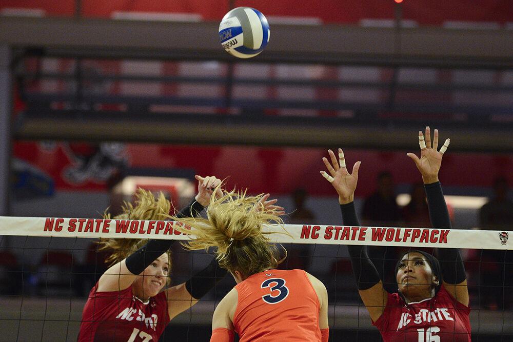 Junior opposite hitter Amanda Rice and junior middle blocker Jada Allen jump to block the ball during the match versus Virginia at Reynolds Coliseum on Sunday, Oct. 22, 2023. NC State beat Virginia 3-0.