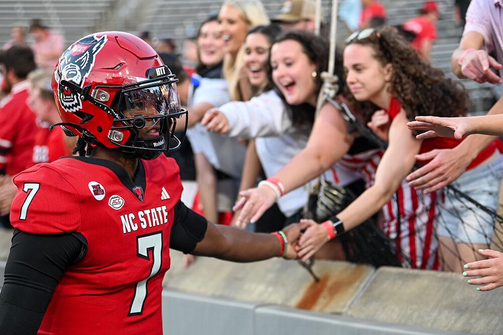 Sophomore quarterback MJ Morris high-fives fans at the conclusion of the game against Marshall at Carter-Finley Stadium on Saturday, Oct. 7, 2023. Morris had 265 rushing yards and four passing touchdowns. NC State beat Marshall 48-41.