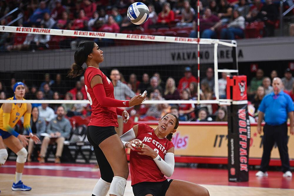 Junior middle blocker Jada Allen prepares to watches the ball as senior setter Naomi Cabello dives into her during the match against Pitt at Reynolds Coliseum on Friday, Oct. 20, 2023. NC State lost to Pitt 3-0.