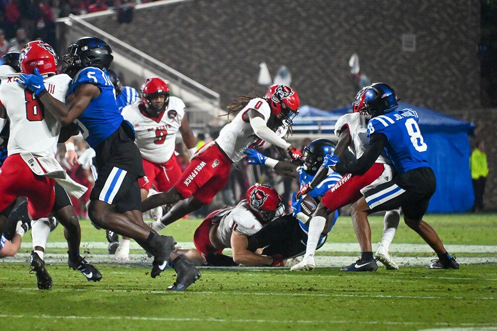 Graduate linebacker Payton Wilson tackles a Blue Devils player during the Wolfpack's game against the Duke Blue Devils at Wallace Wade Stadium on Saturday, Oct. 14, 2023. Wilson had 11 tackles. The Blue Devils beat the Wolfpack 24-3.