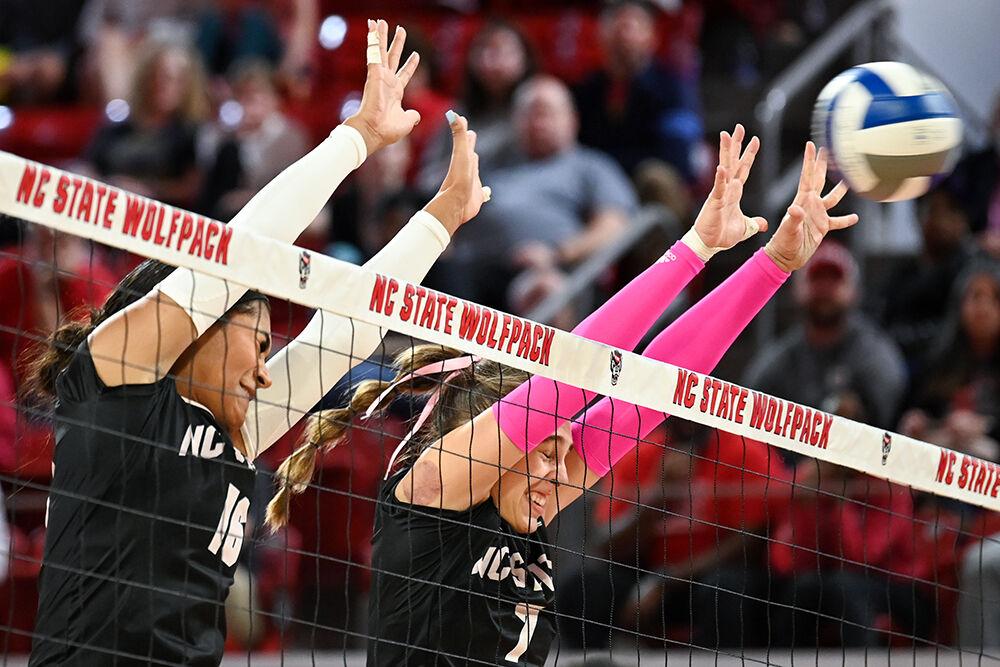 Junior middle blocker Jada Allen and sophomore outside hitter Ava Brizard jump to block the ball during the annual Pink Match against Virginia Tech at Reynolds Coliseum on Sunday, Oct. 15, 2023. Allen and Brizard combined for 19 kills. NC State beat Virginia Tech 3-0.