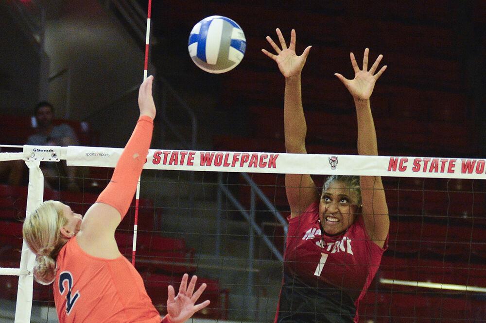 Redshirt junior outside hitter Madison Williams jumps to block the ball during the match versus Virginia at Reynolds Coliseum on Sunday, Oct. 22, 2023. NC State beat Virginia 3-0.