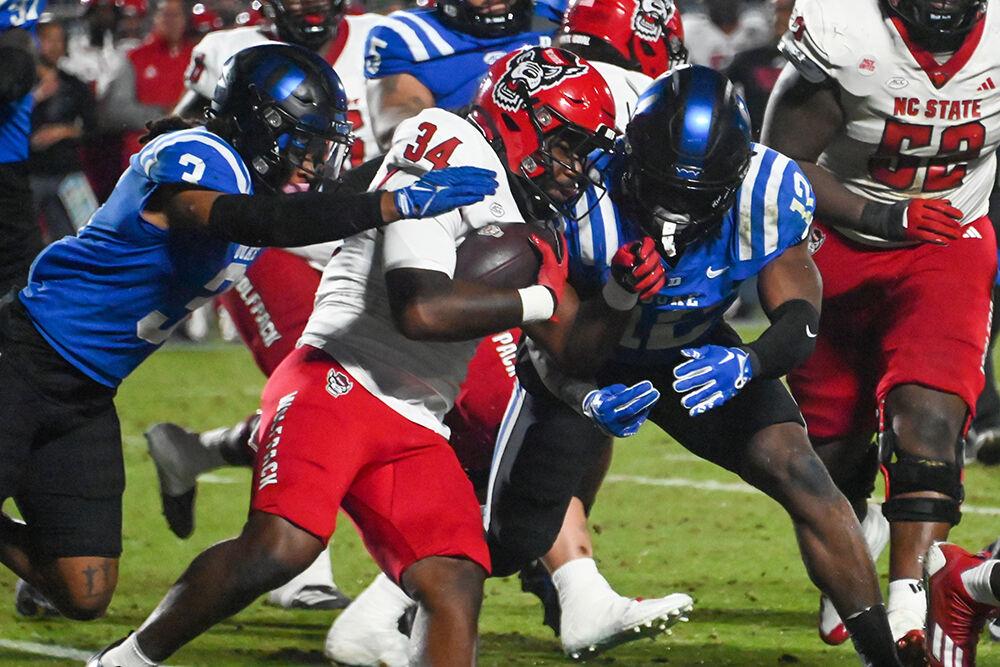 Redshirt Junior running back Delbert Mimms III fights for yards against the Blue Devils defense during the Wolfpack's game against the Duke Blue Devils at Wallace Wade Stadium on Saturday, Oct. 14, 2023. Mimms had 14 yards rushing. The Blue Devils beat the Wolfpack 24-3..