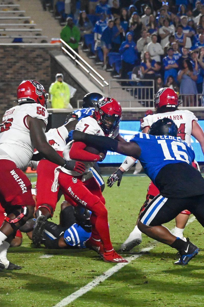 Sophomore quarterback MJ Morris gets sacked by the Blue Devils defense during the Wolfpack's game against the Duke Blue Devils at Wallace Wade Stadium on Saturday, Oct. 14, 2023. Morris had 193 passing yards and 38 rushing yards. The Blue Devils beat the Wolfpack 24-3.