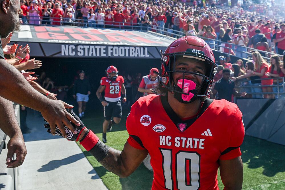 Freshman wide receiver Kevin Concepcion high-fives fans before the game against Marshall at Carter-Finley Stadium on Saturday, Oct. 7, 2023. Concepcion scored two touchdowns for the Wolfpack. NC State beat Marshall 48-41.