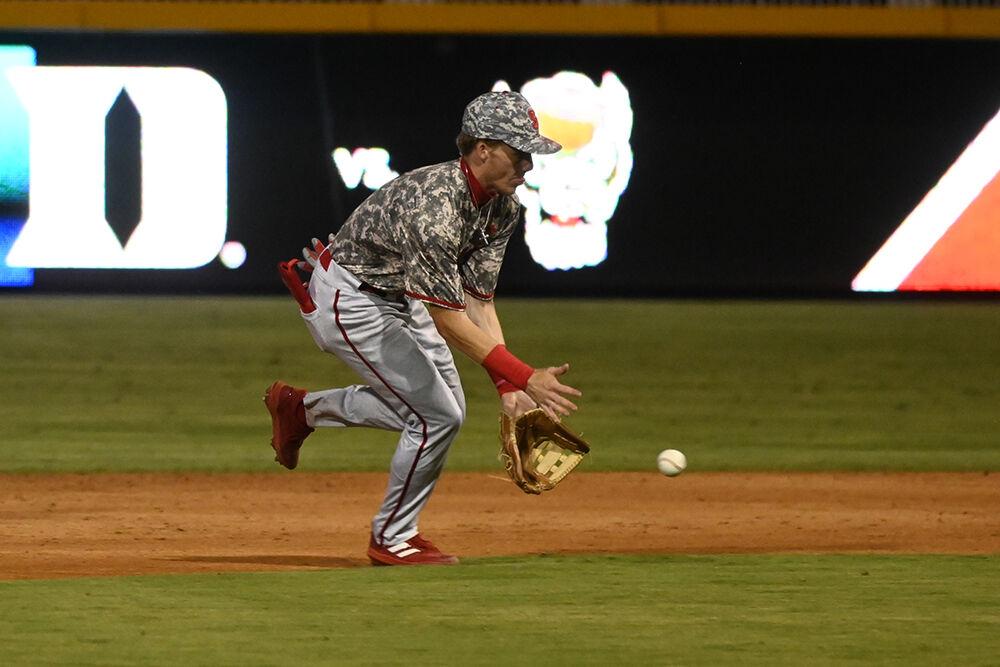 Junior infielder Brandon Butterworth picks up a ground ball in the infield and makes the play to first during the Wolfpack's fall-ball game against the Duke Blue Devils at the Durham Bulls Athletic Park on Friday, Oct. 13, 2023. The Wolfpack beat the Blue Devils 10-3 in game one and 5-1 in game two of the doubleheader event.