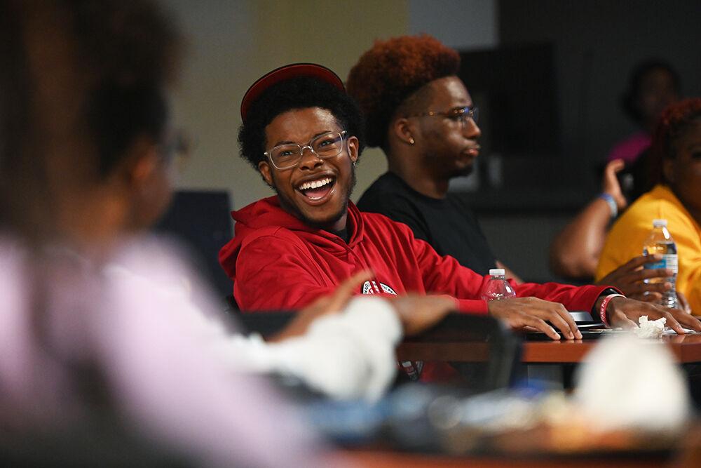 Chris Virella, a fourth-year studying industrial systems engineering, laughs during Family Feud at Witherspoon Student Center on Friday, Oct. 6, 2023. This was one of the many events held during National Pan-Hellenic Council Week at NC State.