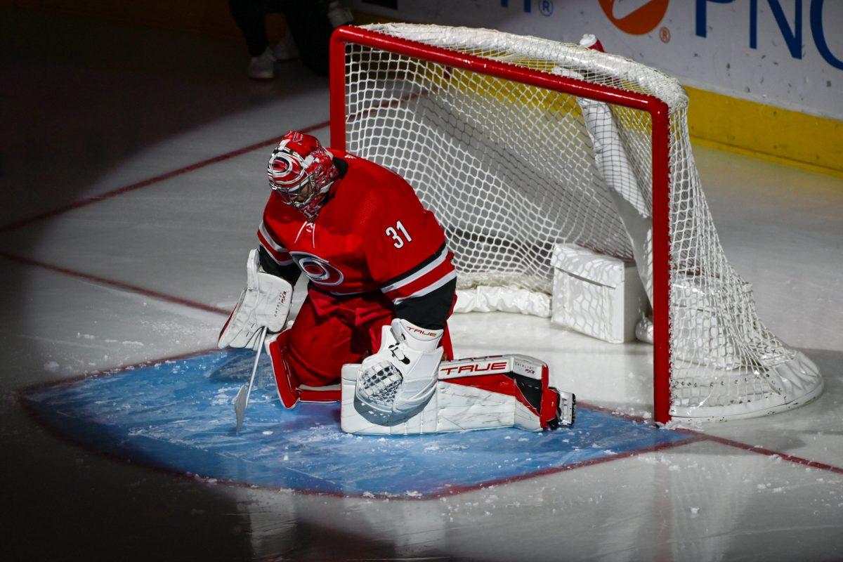 Carolina Hurricanes goaltender Frederik Andersen prepares under a spotlight before the game against the Seattle Kraken in PNC Arena on Thursday, Oct. 26, 2023. Andersen only allowed two goals in the first period. The Hurricanes beat the Kraken 3-2 in overtime.