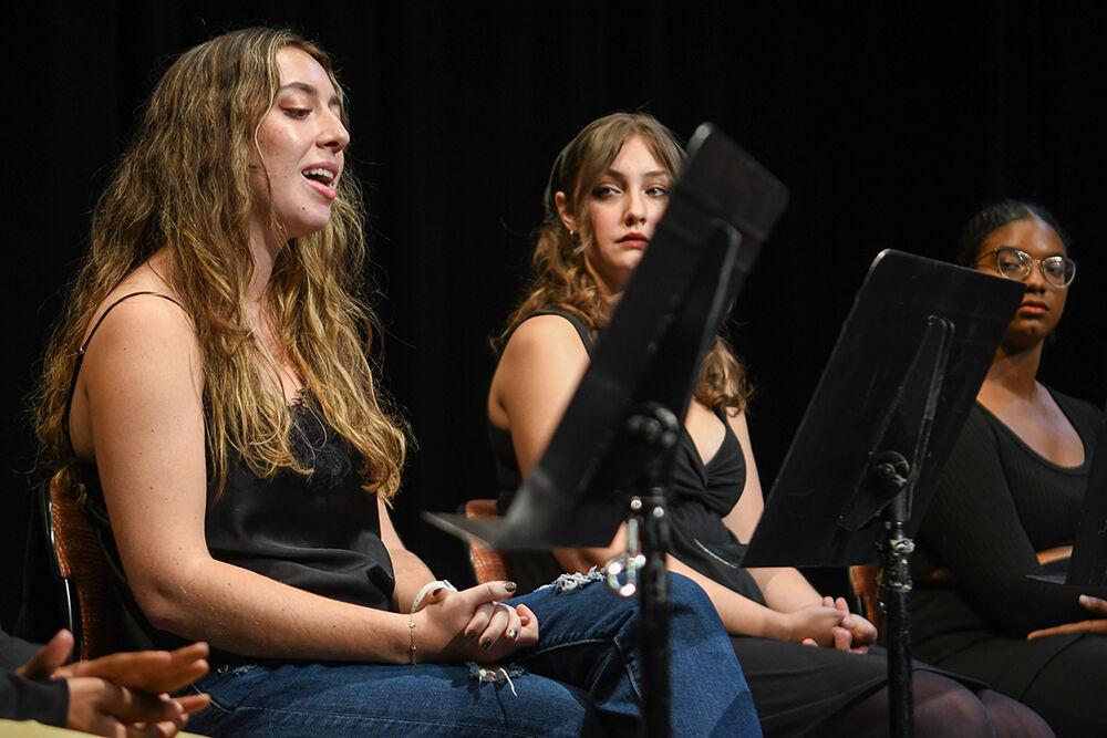 Emma Collins (left), a fourth-year studying business administration, reads a portion of a banned book aloud in Kennedy-McIlwee Studio Theatre on Tuesday, Oct. 3, 2023. Banned Books Week started Oct. 1 and ends Oct. 7.