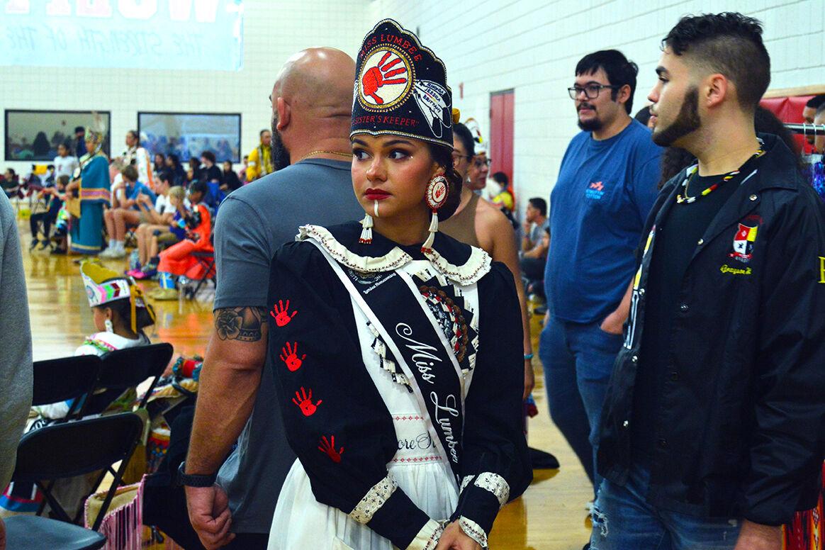 Mahlea Hunt, a Wake Forest University student who holds the title of Miss Lumbee 2022, stands outside the arena at the 32nd Annual NC State Powwow in Carmichael Gymnasium on Saturday, April 1, 2023. NC State's 32nd Annual Powwow celebrated Indigenous culture with traditional drum groups and a display of different Indigenous dance styles. Hunt danced in the Red Dress Women's Special.