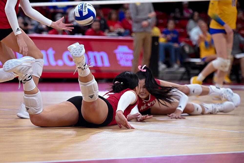 Graduate setter Kristen McDaniel and senior middle blocker Riley Shaak dive for the ball during the match against Pitt at Reynolds Coliseum on Friday, Oct. 20, 2023. NC State lost to Pitt 3-0.