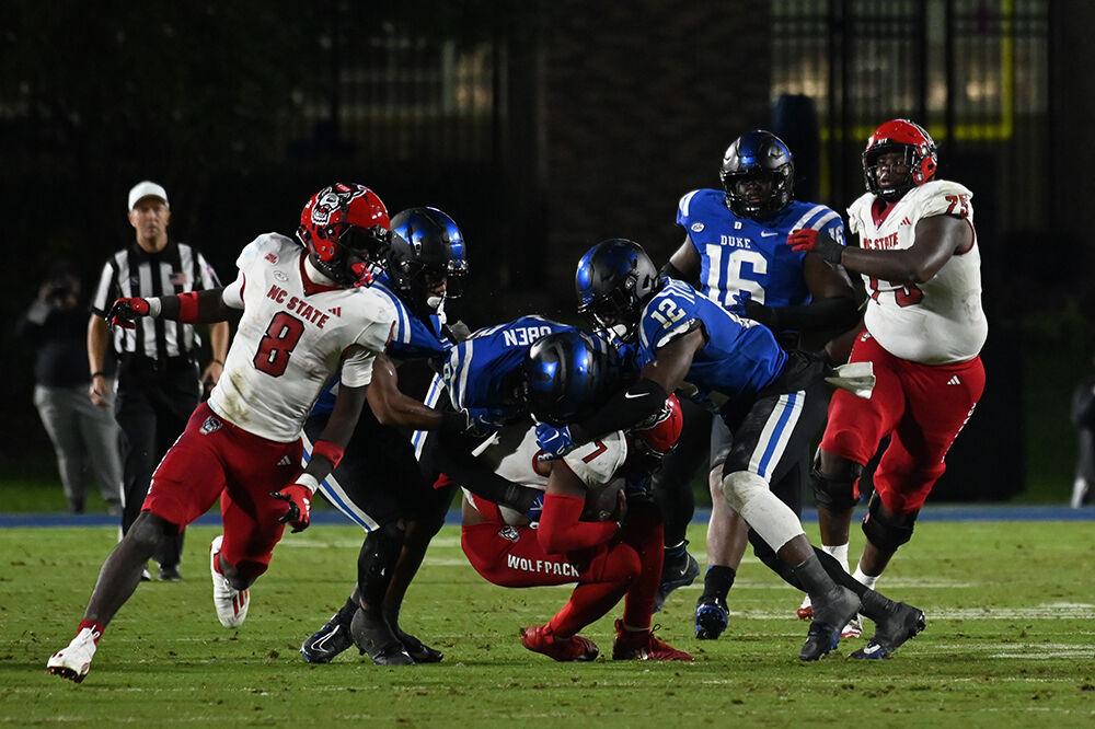 Sophomore quarterback MJ Morris is tackled by the Duke defense during the Wolfpack's game against the Blue Devils at Wallace Wade Stadium on Saturday, Oct. 14, 2023. The Blue Devils defeated the Wolfpack 24-3.