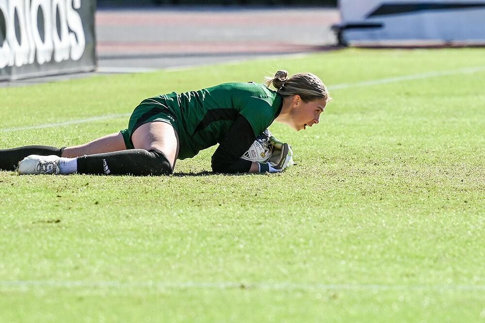 Junior goalkeeper Olivia Pratapas stops a goal during the match versus the Virginia Cavaliers at Dail Soccer Field on Sunday, Oct. 8, 2023. Pratapas had 4 saves against Virginia. The Wolfpack beat the Cavaliers 2-1.