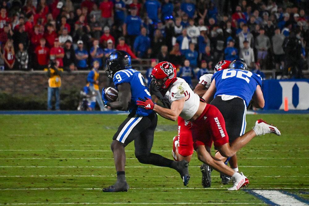 Graduate linebacker Payton Wilson tackles a Blue Devils player during the Wolfpack's game against the Duke Blue Devils at Wallace Wade Stadium on Saturday, Oct. 14, 2023. Wilson had 11 tackles. The Blue Devils beat the Wolfpack 24-3.