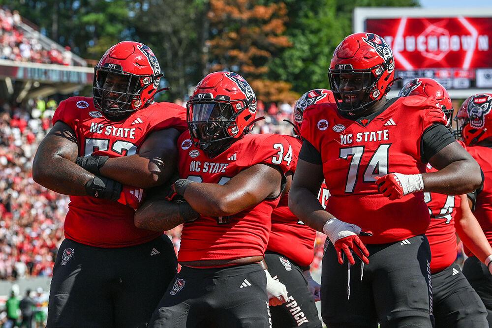 Redshirt junior offensive lineman Timothy McKay, redshirt junior running back Delbert Mimms and redshirt junior offensive lineman Anthony Belton pose with their arms crossed in celebration of a touchdown during the game against Marshall at Carter-Finley Stadium on Saturday, Oct. 7, 2023. Mimms scored one rushing touchdown for the Wolfpack. NC State beat Marshall 48-41.