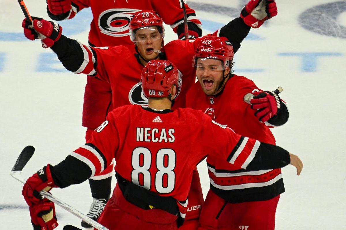 Carolina Hurricanes center Sebastian Aho (rear), left wing Brendan Lemieux (middle) and center Martin Necas celebrate an overtime win during the game against the Seattle Kraken in PNC Arena on Thursday, Oct. 26, 2023. The Hurricanes scored the final goal with ten seconds left in overtime. The Hurricanes beat the Kraken 3-2.