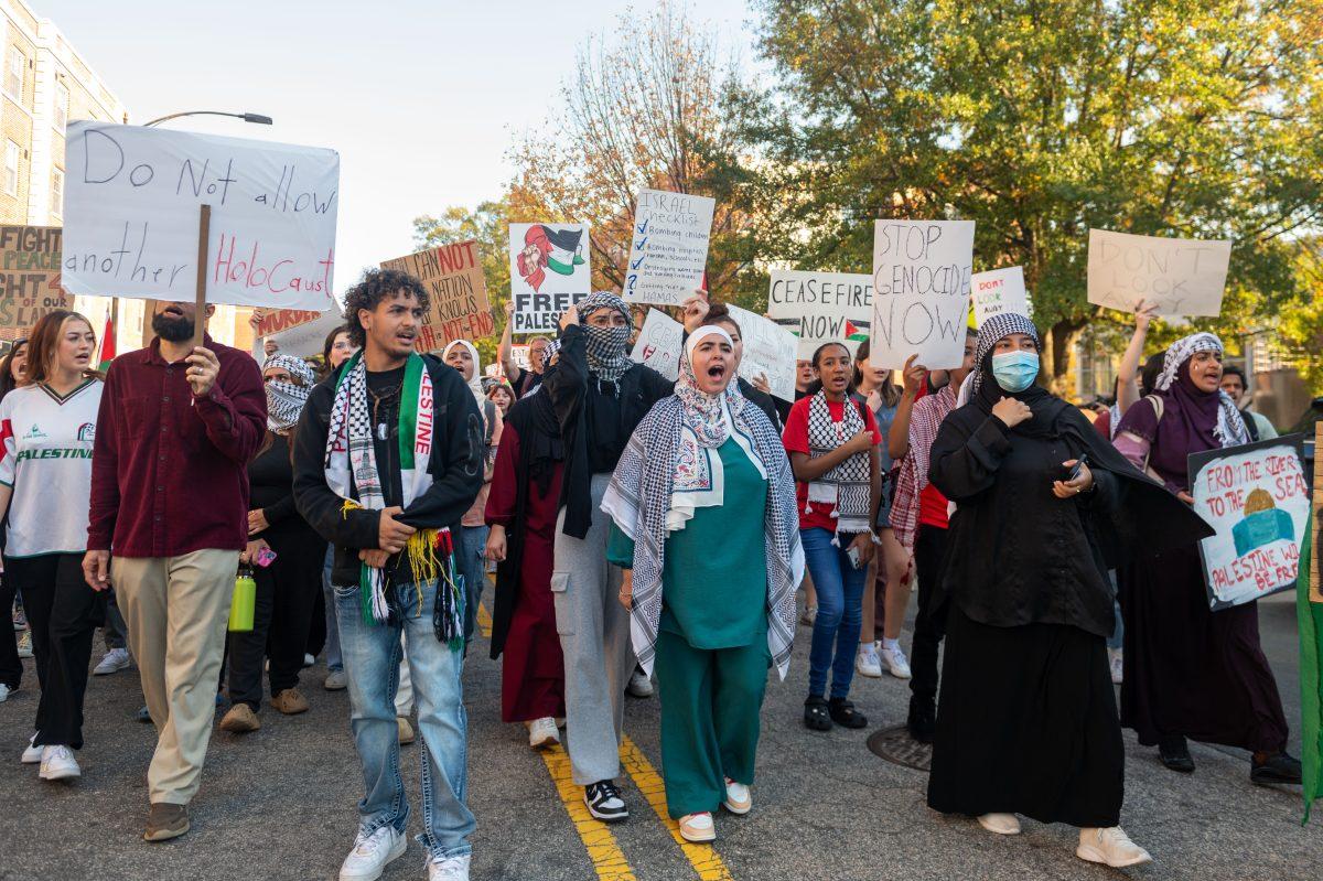 NC State students march down Cates Avenue for the 'Shut it Down! For Palestine' protest Thursday, Nov. 9, 2023. Students started marching at D.H. Hill Library.