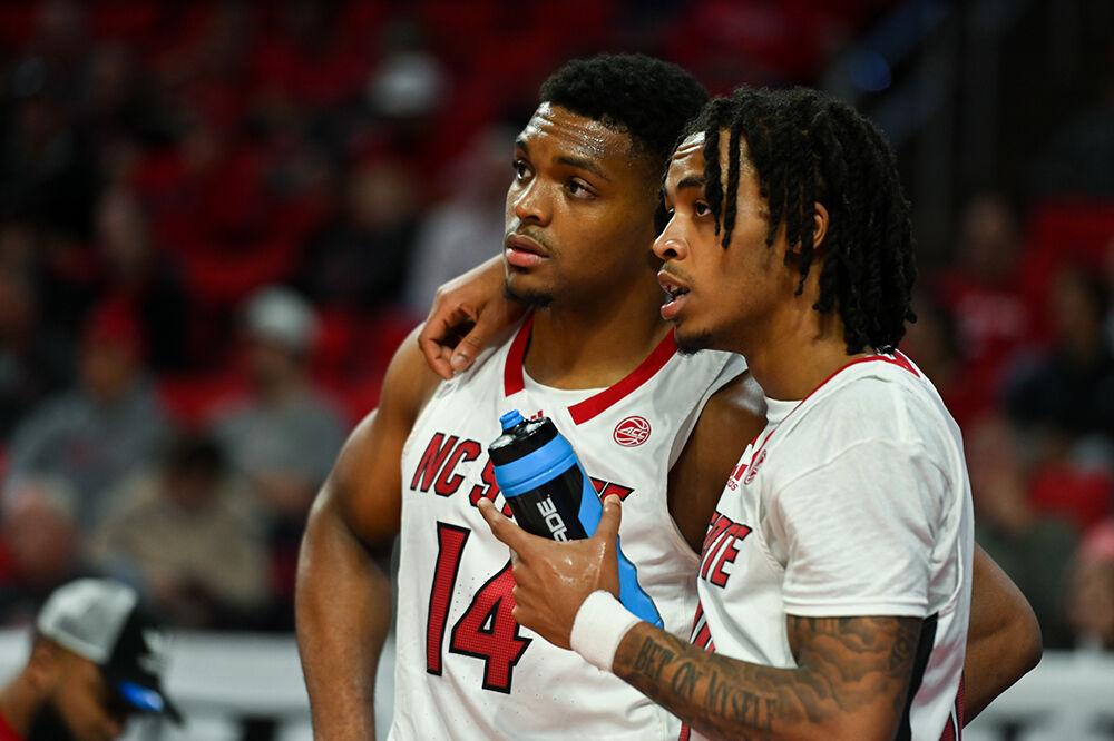 Junior guard Breon Pass talks strategy with graduate guard Casey Morsell during the game versus the Mount Olive Trojans in PNC Arena on Wednesday, Nov. 1, 2023. The Wolfpack beat the Trojans 89-79.