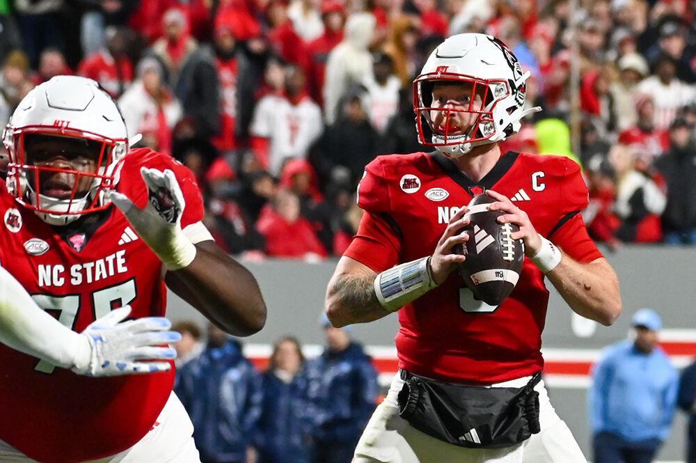 Graduate quarterback Brennan Armstrong looks for a teammate to pass the ball to during the game against UNC-Chapel Hill at Carter-Finley Stadium on Saturday, Nov. 25, 2023. Armstrong made three touchdowns for the Wolfpack. NC State beat UNC-Chapel Hill 39-20.