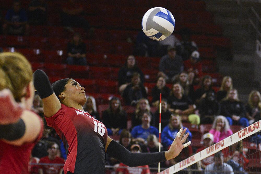 Junior middle blocker Jada Allen jumps to spike the ball during the match versus Virginia at Reynolds Coliseum on Sunday, Oct. 22, 2023. NC State beat Virginia 3-0.