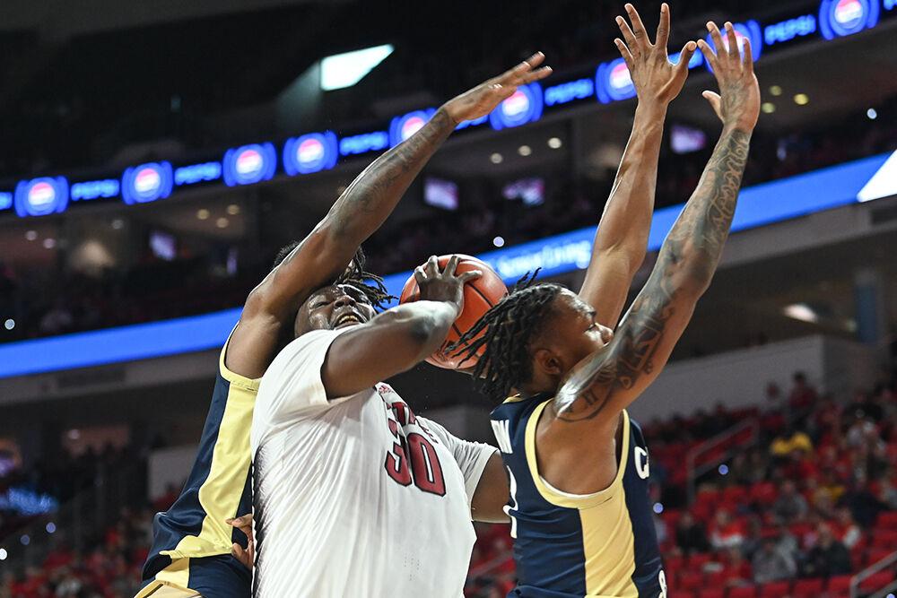 Graduate forward DJ Burns shoots the ball through the defense during the game against Charleston Southern in PNC Arena on Friday, Nov. 17, 2023. Burns scored 16 points, made one block and one assist. NC State beat Charleston Southern 87-53.