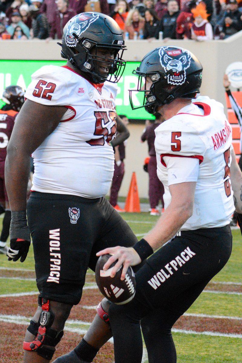 Redshirt junior offensive tackler Timothy McKay (left) and graduate quarterback Brennan Armstrong celebrate a touchdown during the game against Virginia Tech at Lane Stadium on Saturday, Nov. 18, 2023. Wolfpack beat the Hokies 35-28.