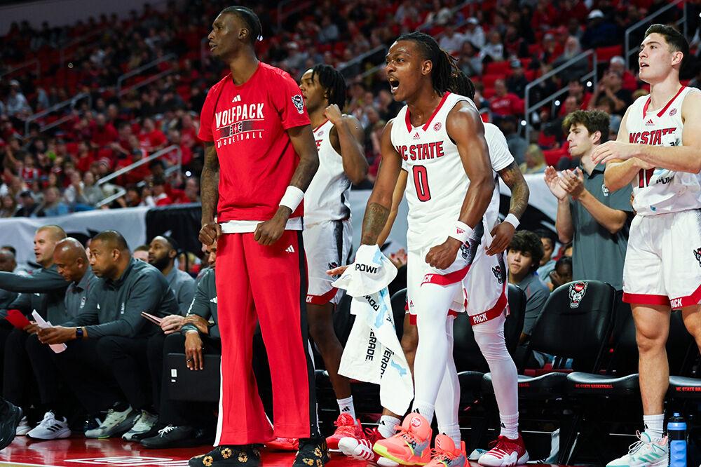 The NC State bench celebrates a three pointer during the game versus the Mount Olive Trojans in PNC Arena on Wednesday, Nov. 1, 2023. The Wolfpack beat the Trojans 89-79.