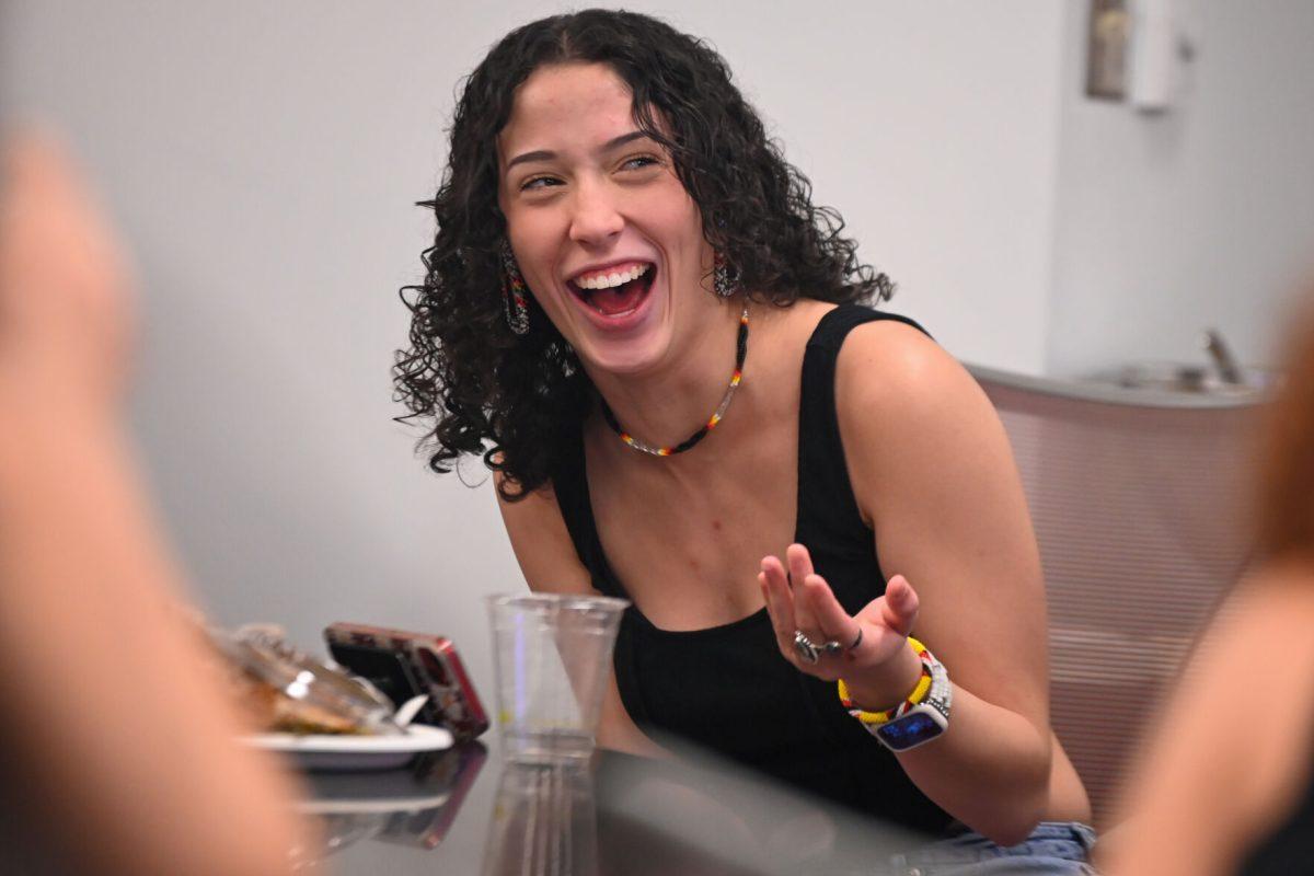 Trinity Locklear, a third-year studying criminology, laughs at someone's joke during the Native American Heritage Month Chat 'n' Chew at Talley Student Union Thursday, Nov. 9, 2023. This event allowed for students of Native American heritage to discuss their experiences on campus over dinner. Attendees spent time fellowshipping with one another and learned about each other&#8217;s experiences.