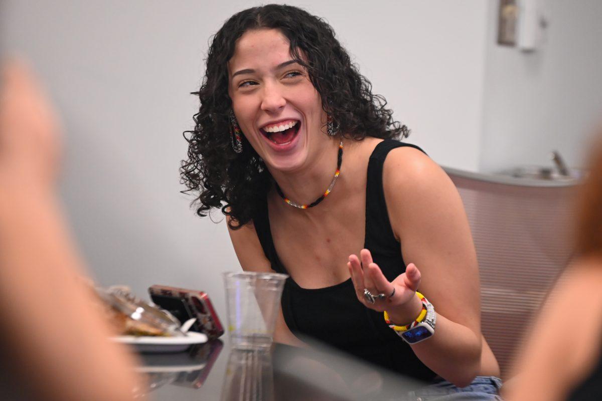 Trinity Locklear, a third-year studying criminology, laughs at someone's joke during the Native American Heritage Month Chat 'n' Chew at Talley Student Union Thursday, Nov. 9, 2023. This event allowed for students of Native American heritage to discuss their experiences on campus over dinner. Attendees spent time fellowshipping with one another and learned about each other&#8217;s experiences.
