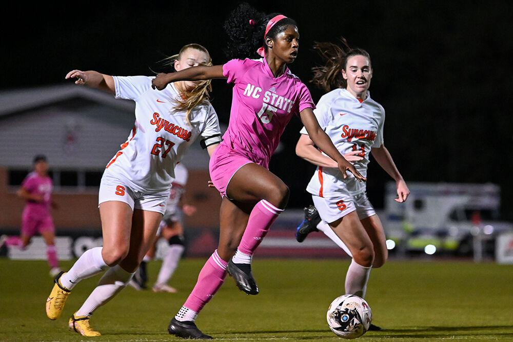 Senior forward Jameese Joseph dribbles the ball as Syracuse defense closes in during the match at Dail Soccer Field on Thursday, Oct. 19, 2023. Joseph made one shot on the goal. NC State beat Syracuse 2-0.