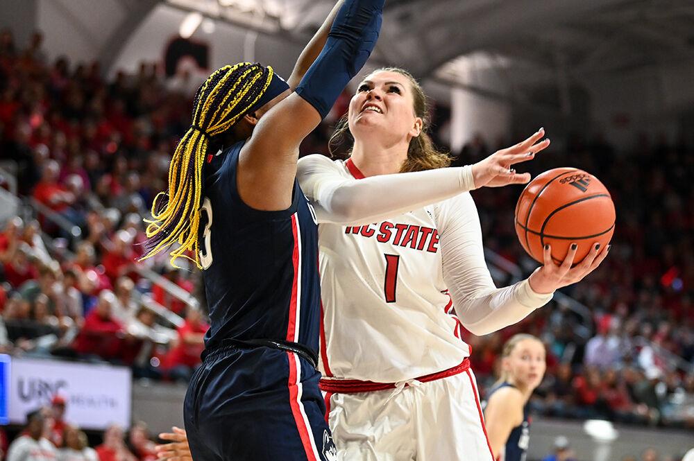 Graduate center River Baldwin drives the ball to the basket during the game against UConn in Reynolds Coliseum on Sunday, Nov. 12, 2023. Baldwin scored six points and had one steal. NC State defeated UConn 92-81.