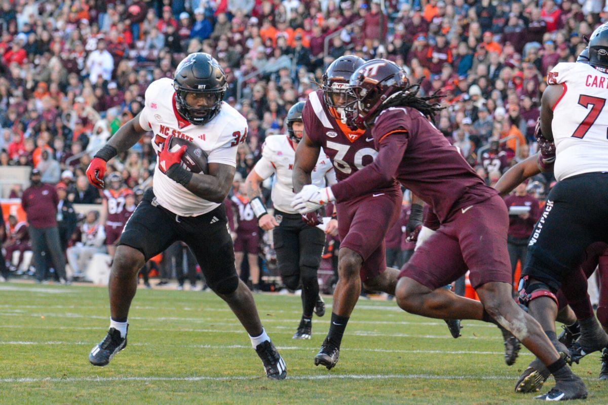 Redshirt junior running back Delbert Mimms III runs down the field during the game against Virginia Tech at Lane Stadium on Saturday, Nov. 18, 2023. Wolfpack beat the Hokies 35-28.