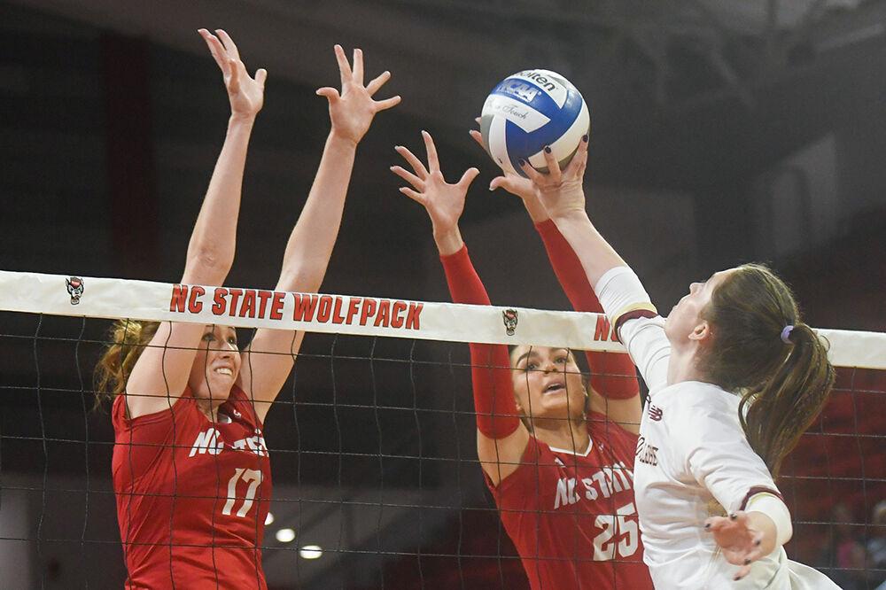 Junior opposite hitter Amanda Rice (left) and senior middle blocker Riley Shaak (right) attempt to deflect a ball in the match against Boston College inside Reynolds Coliseum on Friday, Nov. 3, 2023. NC State lost the match 3-2.