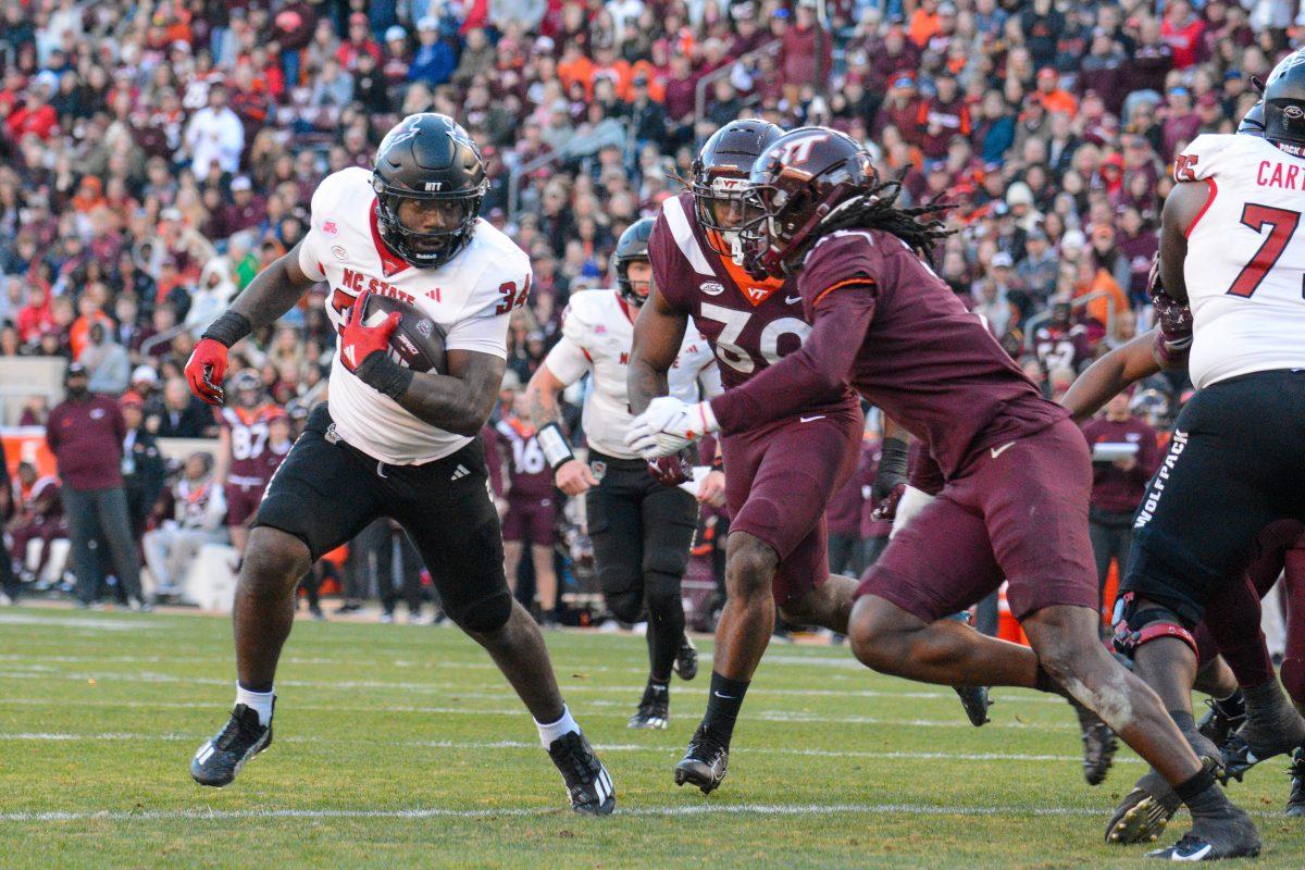 Redshirt junior running back Delbert Mimms III runs down the field during the game against Virginia Tech at Lane Stadium on Saturday, Nov. 18, 2023. Wolfpack beat the Hokies 35-28.