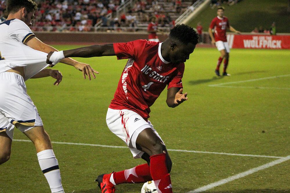 Freshmen left-center back Lawson Abass defends the ball from Notre Dame during the home soccer game at Dail Soccer Field on Oct. 1, 2023. NC State lost to Notre Dame 3-1.